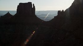 5.5K aerial stock footage fly through gap between United Nations Tablet butte and cliffs to reveal Canyonlands National Park, Utah Aerial Stock Footage | AX138_183E