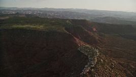 5.5K aerial stock footage of passing by desert mesa and box canyon, Moab, Utah Aerial Stock Footage | AX138_275E