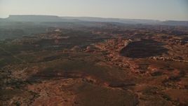 5.5K aerial stock footage of flying over rock formations and box canyons, Canyonlands National Park, Utah, sunset Aerial Stock Footage | AX138_287E