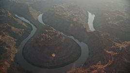 5.5K aerial stock footage of orbiting the river at the bottom of Meander Canyon, Canyonlands National Park, Utah, sunset Aerial Stock Footage | AX138_310E