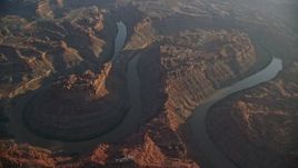 5.5K aerial stock footage of the river flowing through Meander Canyon in Canyonlands National Park, Utah, sunset Aerial Stock Footage | AX138_313E