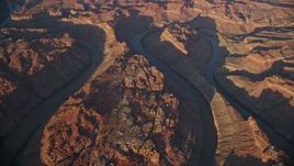 5.5K aerial stock footage of an orbit of the river at sunset, bottom of Meander Canyon, Canyonlands National Park, Utah Aerial Stock Footage | AX138_324E
