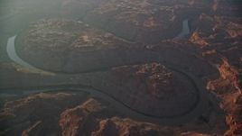 5.5K aerial stock footage of Colorado River running through Meander Canyon at sunset in Canyonlands National Park, Utah Aerial Stock Footage | AX138_330E