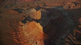 5.5K aerial stock footage of approaching a butte in Lockhart Canyon, Moab, Utah, sunset Aerial Stock Footage | AX138_344