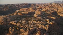 5.5K aerial stock footage of flying over box canyon and rock formations, Moab, Utah, sunset Aerial Stock Footage | AX138_369E