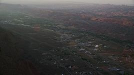 5.5K aerial stock footage of passing by a small town, Moab, Utah, sunset Aerial Stock Footage | AX138_375E