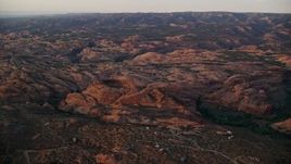 5.5K aerial stock footage of flying over petrified sand dunes, Sand Flats Recreation Area, Utah, sunset Aerial Stock Footage | AX138_378E