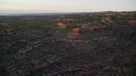 5.5K aerial stock footage of flying over open desert and vegetation, Moab, Utah, sunset Aerial Stock Footage | AX138_381E