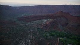 5.5K aerial stock footage of approaching rock formations near Dry Mesa cliffs, Moab, Utah, sunset Aerial Stock Footage | AX138_395E