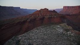 5.5K aerial stock footage of passing the Colorado River with view of distant mesas, revealing Red Cliffs Lodge, Moab, Utah, sunset Aerial Stock Footage | AX138_397E