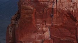 5.5K aerial stock footage of a rock climber on Castleton Tower, Moab, Utah, sunset Aerial Stock Footage | AX138_419E