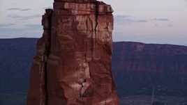 5.5K aerial stock footage of an orbit around a rock climber on Castleton Tower, Moab, Utah, sunset Aerial Stock Footage | AX138_423