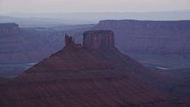 5.5K aerial stock footage of passing by two desert buttes, Moab, Utah, sunset Aerial Stock Footage | AX138_425E