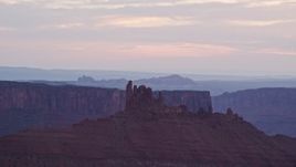 5.5K aerial stock footage of passing a desert butte at sunset, Moab, Utah Aerial Stock Footage | AX138_427