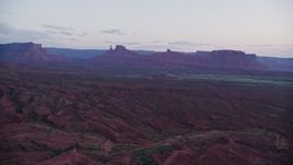 5.5K aerial stock footage of giant desert buttes across valley, Moab, Utah, twilight Aerial Stock Footage | AX138_449E
