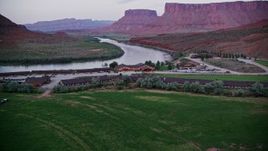 5.5K aerial stock footage of flying by and approaching Red Cliffs Lodge near Colorado River, Moab, Utah, twilight Aerial Stock Footage | AX138_462