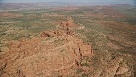 5.5K aerial stock footage of flying over rock formations and desert valley, Arches National Park, Utah Aerial Stock Footage | AX139_001E