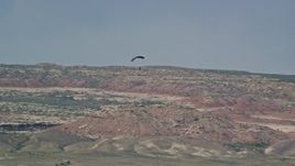 5.5K aerial stock footage of a skydiver landing in Canyonlands Field, Utah Aerial Stock Footage | AX139_016E