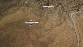 5.5K aerial stock footage of two planes, Tecnam P2006T and Cessna, flying over desert, Grand County, Utah Aerial Stock Footage | AX139_046