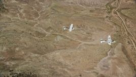 5.5K aerial stock footage of Tecnam P2006T, Cessna flying over desert, Grand County, Utah Aerial Stock Footage | AX139_047