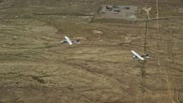 5.5K aerial stock footage of Tecnam P2006T and Cessna flying above the desert, Grand County, Utah Aerial Stock Footage | AX139_048E