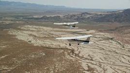 5.5K aerial stock footage track Tecnam P2006T and Cessna planes flying over the desert, Grand County, Utah Aerial Stock Footage | AX139_054E