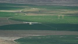 5.5K aerial stock footage of a Tecnam P2006T near circular crop fields, reveal Cessna, Green River, Utah Aerial Stock Footage | AX139_087E