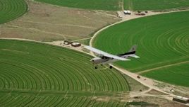 5.5K aerial stock footage of an air to air view of a Cessna over circular crop fields, Green River, Utah Aerial Stock Footage | AX139_096E