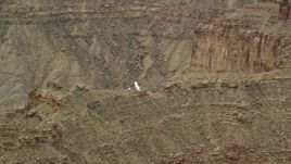 5.5K aerial stock footage of tracking a Cessna flying by desert buttes, Emery County, Utah Aerial Stock Footage | AX139_101E