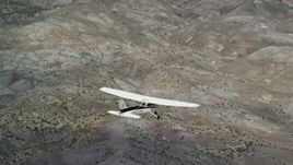 5.5K aerial stock footage focus on a Cessna in flight high above desert vegetation, Emery County, Utah Aerial Stock Footage | AX139_131E