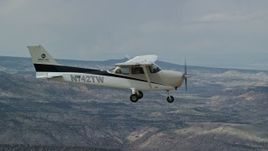 5.5K aerial stock footage of a view of a Cessna over desert mountains, seen from above, Carbon County, Utah Aerial Stock Footage | AX139_146E