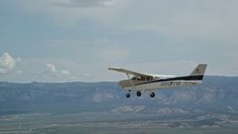 5.5K aerial stock footage track a Cessna flying over desert, ascend to bird's eye view of plane, Carbon County, Utah Aerial Stock Footage | AX139_150E