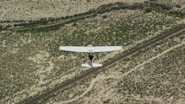 5.5K aerial stock footage of a bird's eye view of a Cessna plane flying over desert, Carbon County, Utah Aerial Stock Footage | AX139_153E