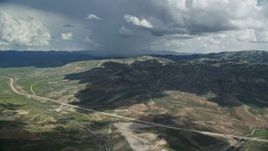 5.5K aerial stock footage of a wide view of mountains and Highway 6, Colton ghost town, clouds, Wasatch Range, Utah County, Utah Aerial Stock Footage | AX140_037E