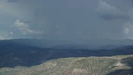 5.5K aerial stock footage of a Tecnam P2006T airplane flying by rainstorm, Wasatch Range, Utah Aerial Stock Footage | AX140_039E
