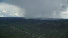 5.5K aerial stock footage track distant Tecnam P2006T and Cessna near rainstorm and Highway 6, Wasatch Range, Utah Aerial Stock Footage | AX140_047E