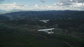 5.5K aerial stock footage of tracking a Cessna flying with a Tecnam P2006T by mountains, Wasatch Range, Utah Aerial Stock Footage | AX140_058E
