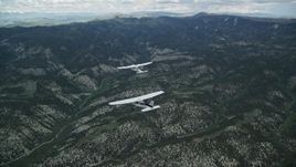 5.5K aerial stock footage tracking Tecnam P2006T flying ahead of Cessna over mountains, Wasatch Range, Utah Aerial Stock Footage | AX140_068E