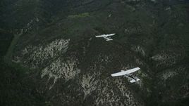 5.5K aerial stock footage of a Tecnam P2006T leading a Cessna over Wasatch Range, Utah Aerial Stock Footage | AX140_074E