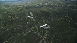 5.5K aerial stock footage of flying around a Tecnam P2006T leading a Cessna over mountains, Wasatch Range, Utah Aerial Stock Footage | AX140_080E
