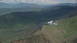 5.5K aerial stock footage of following a Tecnam P2006T over green mountains, Wasatch Range, Utah Aerial Stock Footage | AX140_099E