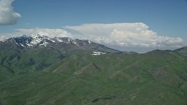 5.5K aerial stock footage of a Tecnam P2006T in flight near near snowy Wasatch Range peak, Utah Aerial Stock Footage | AX140_106E