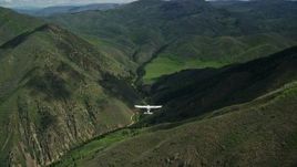 5.5K aerial stock footage of following a Tecnam P2006T over green mountain ridges, Wasatch Range, Utah Aerial Stock Footage | AX140_132