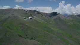 5.5K aerial stock footage track a Tecnam P2006T aircraft passing by green mountains, aspen trees, Wasatch Range, Utah Aerial Stock Footage | AX140_150