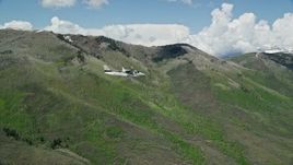 5.5K aerial stock footage fly beside a Tecnam P2006T passing green mountains, Wasatch Range, Utah Aerial Stock Footage | AX140_151E