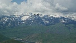 5.5K aerial stock footage of a Tecnam P2006T briefly flying by snow-capped Mount Timpanogos, Utah Aerial Stock Footage | AX140_168