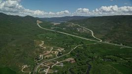5.5K aerial stock footage of a view of Highway 40 through green mountain foothills, Heber City, Utah Aerial Stock Footage | AX140_185E