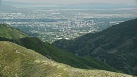 5.5K aerial stock footage of flying over Wasatch Range to approach Downtown Salt Lake City, Utah Aerial Stock Footage | AX140_239E