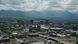5.5K aerial stock footage reverse view of downtown and distant Wasatch Range, Downtown Salt Lake City, Utah Aerial Stock Footage | AX140_260