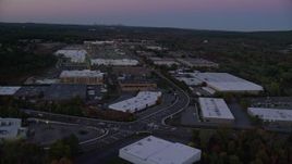 5.5K aerial stock footage of a strip mall, warehouse buildings, University Avenue, Westwood, Massachusetts, twilight Aerial Stock Footage | AX141_001